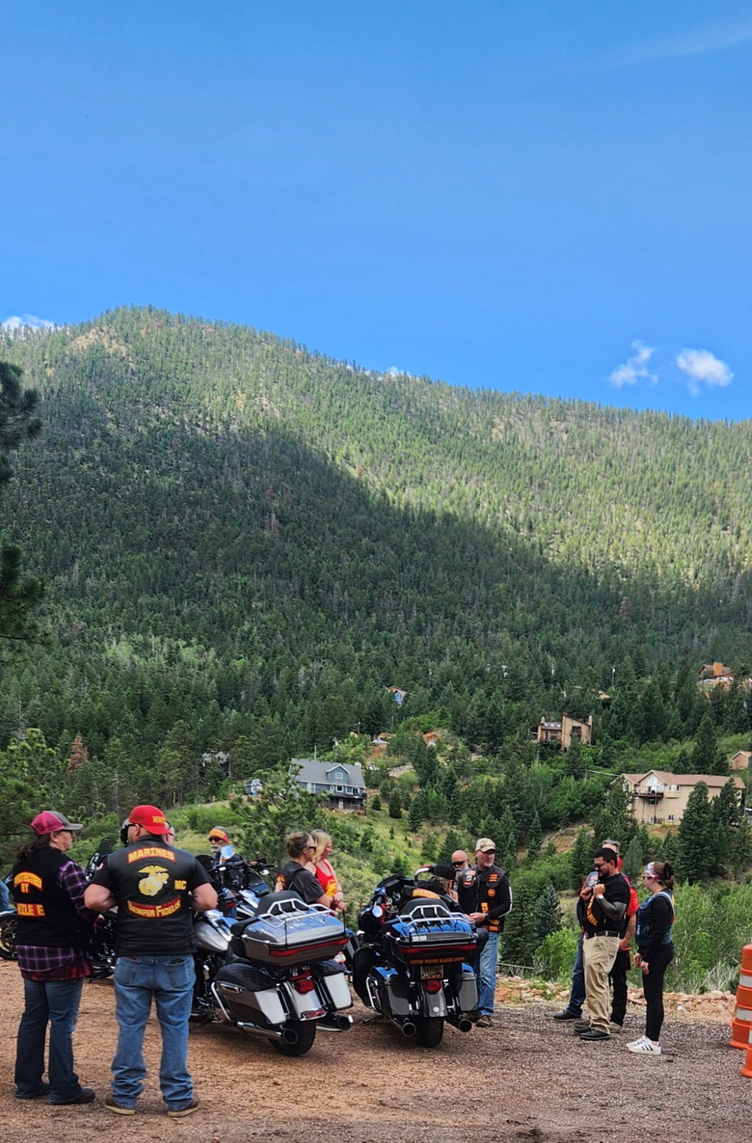 A motorcycle club taking in the Pikes Peak mountain view after visiting The Mad Hatter Saloon in Cascade, CO