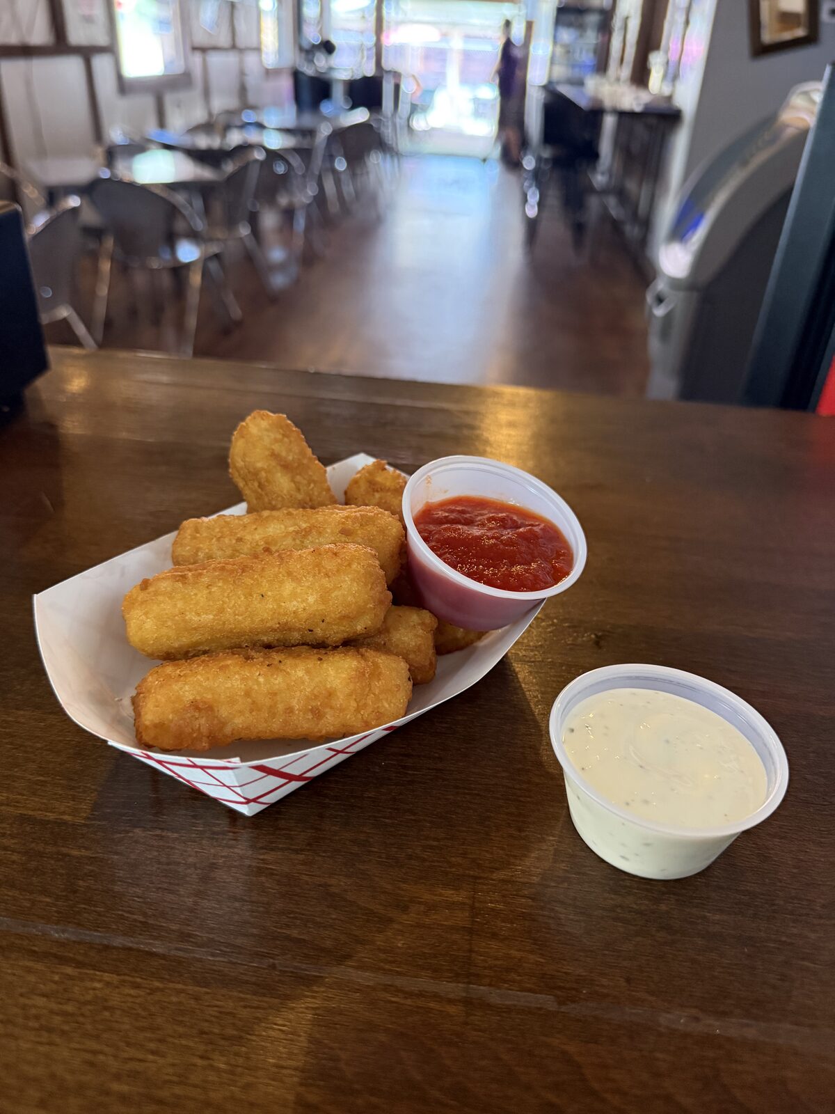Golden fried mozzarella sticks served at The Mad Hatter Saloon in Cascade, CO