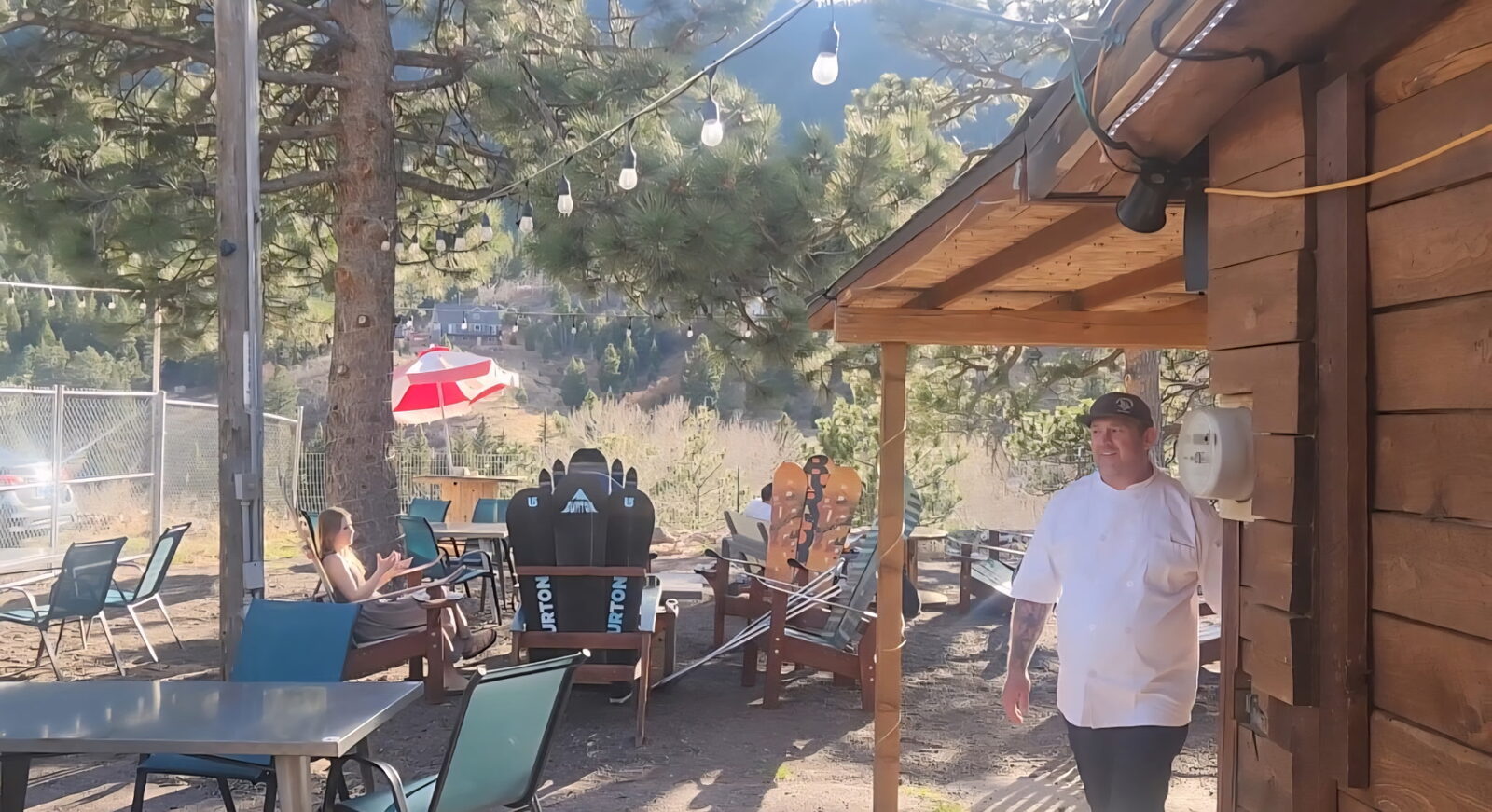 The Mad Hatter Saloon owner and a guest enjoying the Pikes Peak mountain view from the patio in Cascade, CO