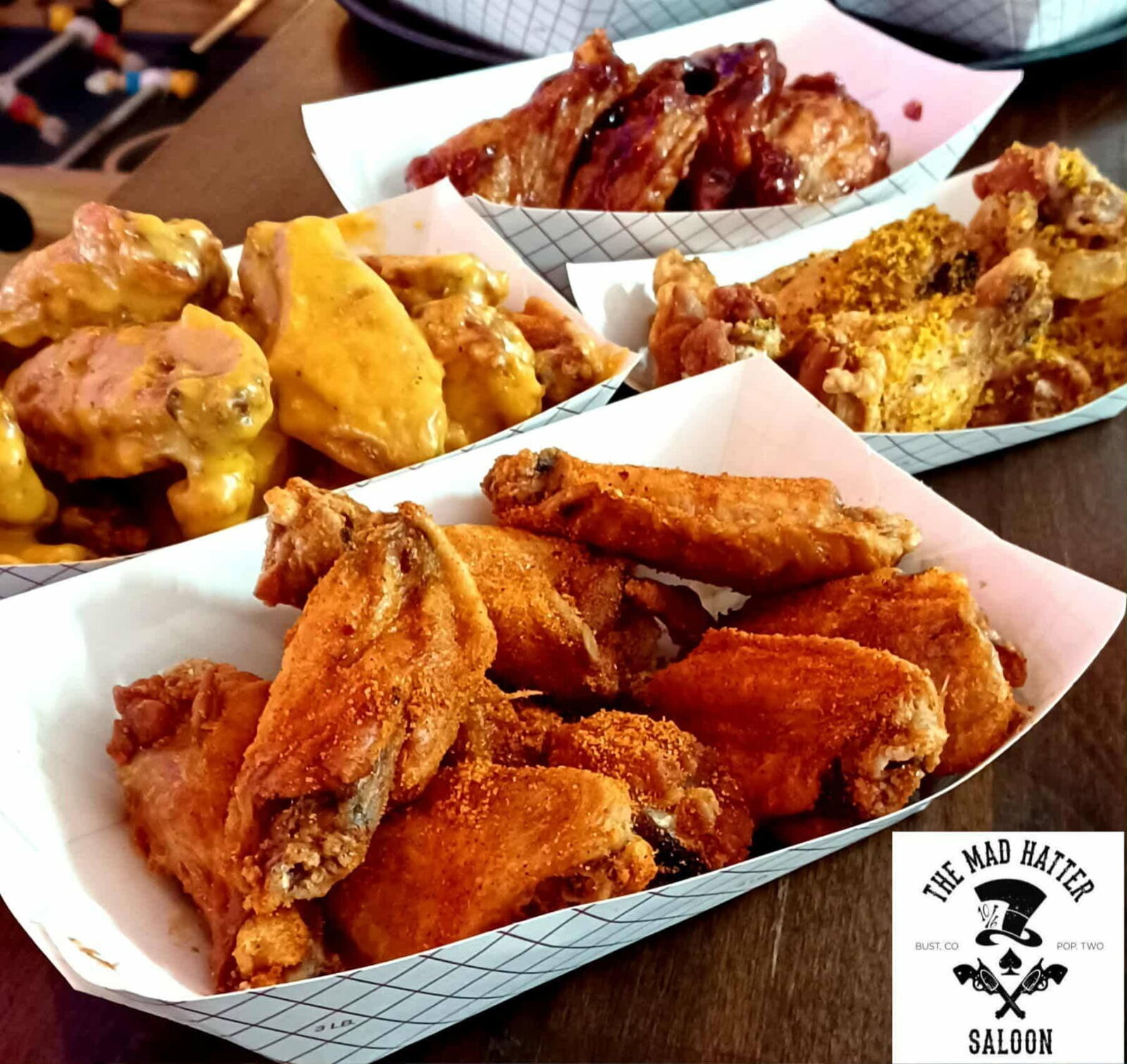 Sampler of Mad Hatter Saloon wings in Buffalo, Garlic Parmesan, BBQ, and dry rub sauces, Cascade, CO